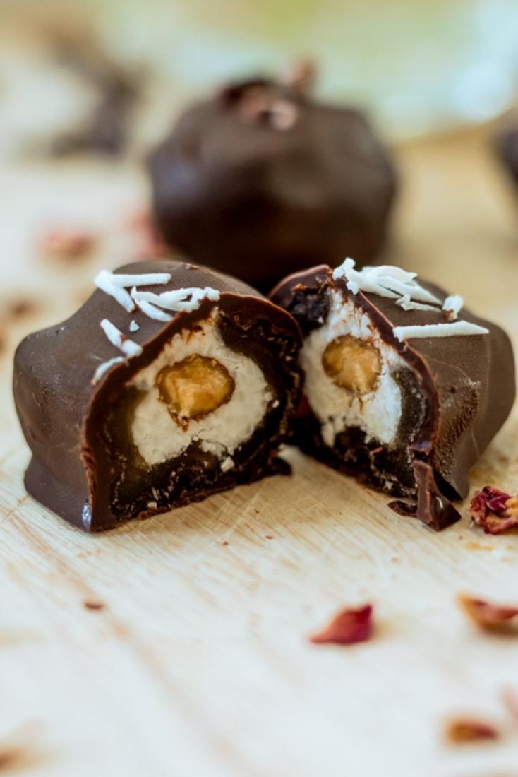 Coconut Almond date bonbon cut in half, coconut cream and a whole almond inside