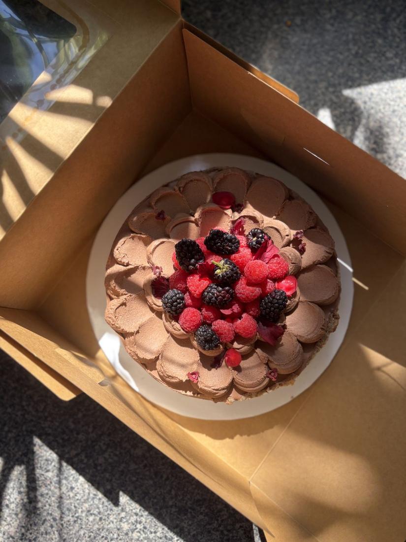 Chocolate cake topped with raspberries and blackberries