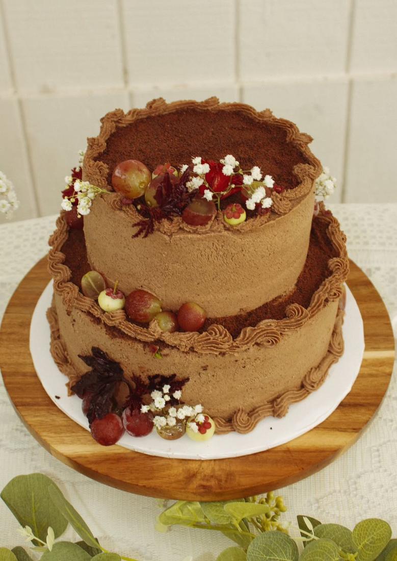 Two tier chocolate cake with grapes and baby's breath